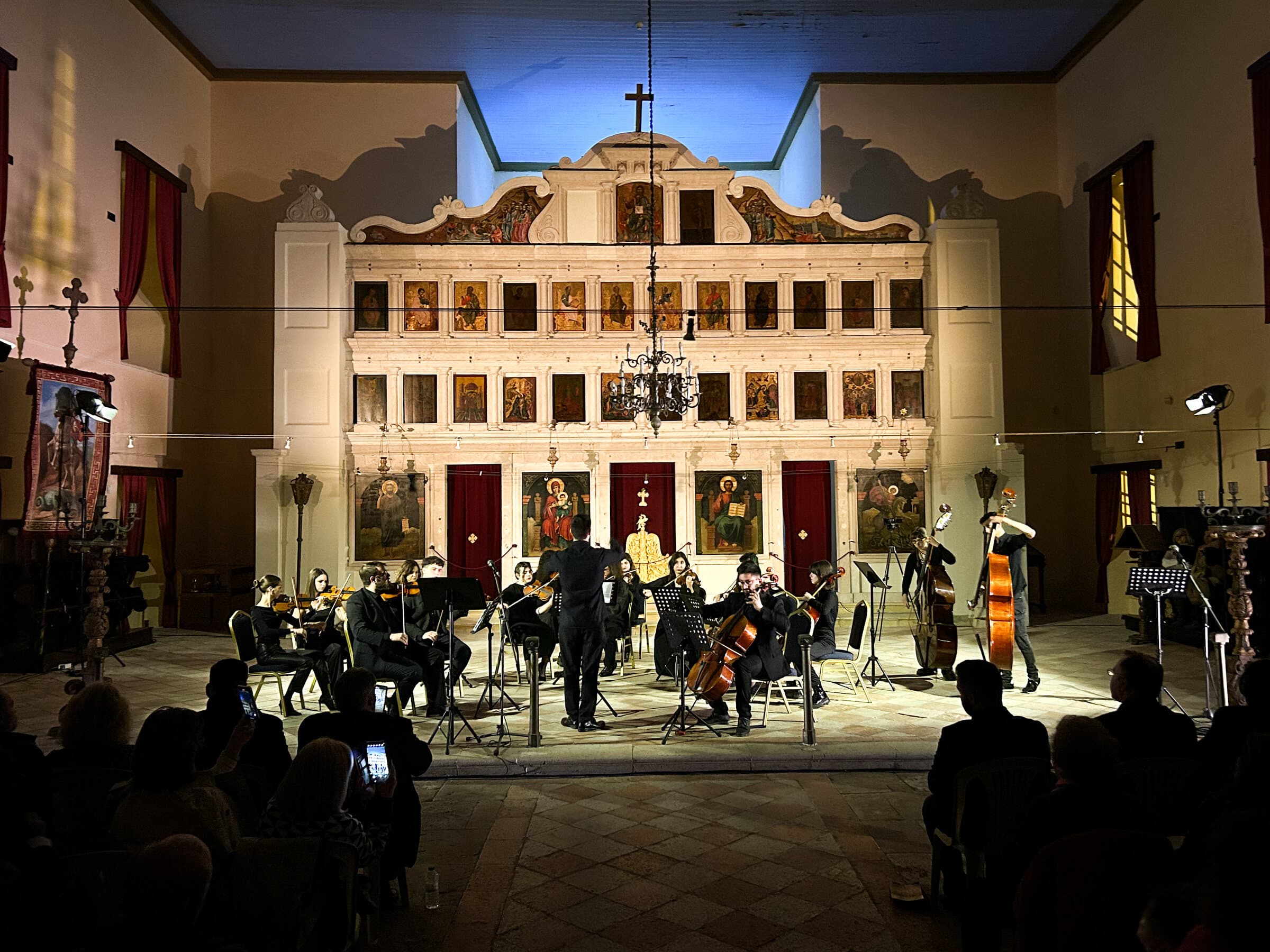 Vaggelis Stavropoulos conducting an orchestra in a church